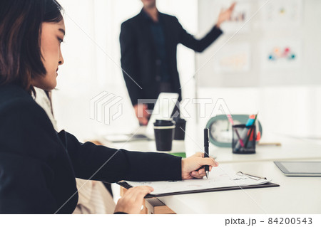 Businesswoman in business meeting writing paper proficiently at office room . 84200543