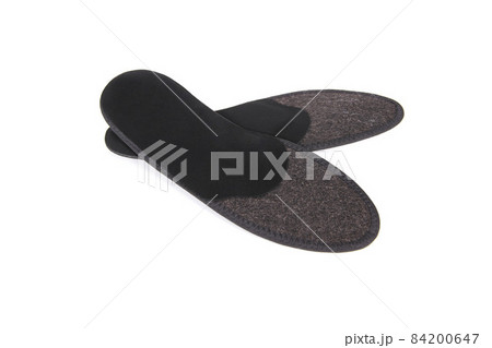 Medical insoles. Isolated orthopedic insoles on a white background. Treatment and prevention of flat feet and foot diseases. Foot care. Insole cutaway layers. 84200647