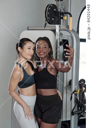 Sportswomen Taking Photot for Social Media 84201448