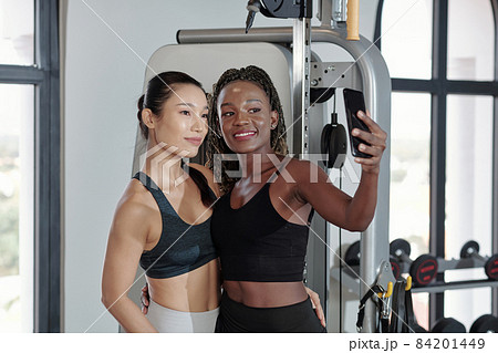 Female Friends Taking Selfie in Gym 84201449