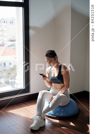 Fitness Trainer Sitting on Hemisphere 84201516