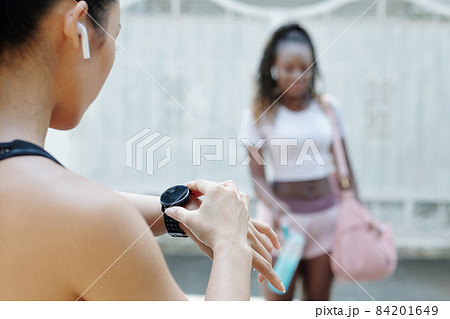 Sportswoman Checking Time on Smartwatch 84201649