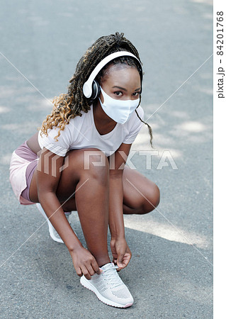 Pretty Female Jogger Tying Shoe Laces 84201768