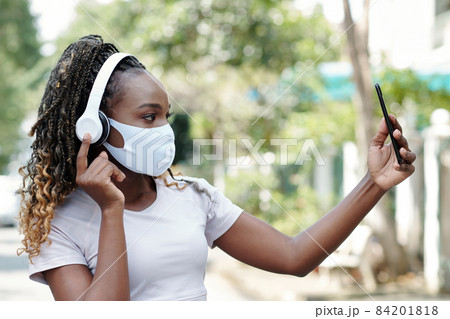 Woman in Medical Mask Taking Selfie 84201818