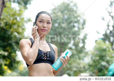Female Jogger Talking on Phone 84201856