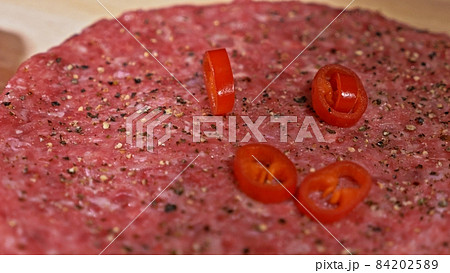 Cook makes meat medallions for burgers. Chef in black food gloves makes cutlet. Cutlets are leveled in steel ring in an even medallion. Cook makes meat medallions for burgers. Chef in black food gloves makes cutlet. Cutlets are leveled in steel ring in an even medallion. 84202589