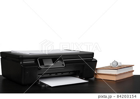 Office table with laser printer and books against white background 84203154