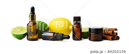 Essential oil bottles and citrus fruit on white background Essential oil bottles and citrus fruit on white background 84203156