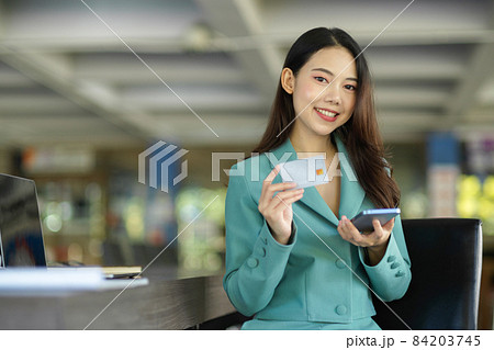 Attractive businesswoman with smart mobile phone and credit card 84203745