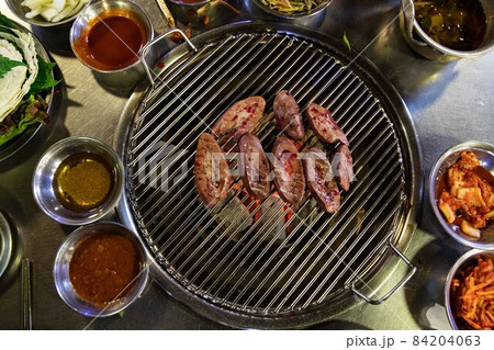 Grilled pork kidneys on charcoal fire, Korean traditional food 84204063