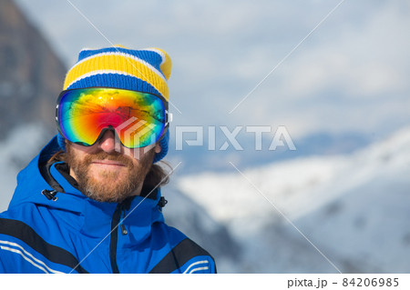 Skier in goggles look at mountains 84206985