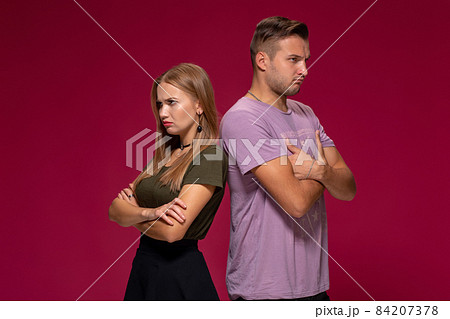 Studio portrait of a young couple in casual wear quarreled and taking a step towards reconciliation. 84207378