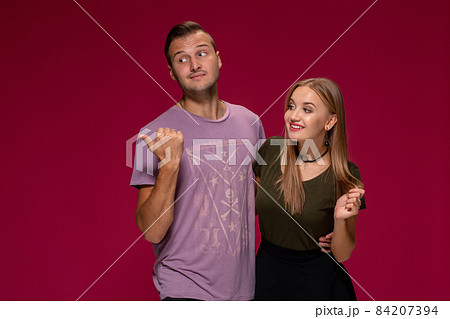People, friendship, love and leisure concept - lovely couple with thumbs-up gesture on burgundy background 84207394