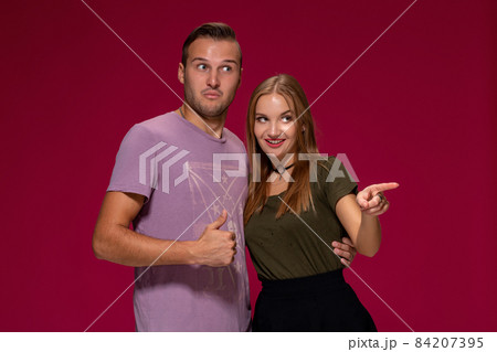 People, friendship, love and leisure concept - lovely couple with thumbs-up gesture on burgundy background 84207395