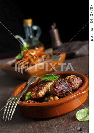 Plate soba with fried cutlets and sauce on a table. Plate soba with fried cutlets and sauce on a table. 84207787
