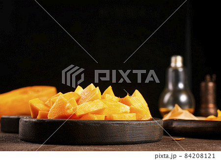raw pumpkin on wooden plate, fresh pumpkin raw pumpkin on wooden plate, fresh pumpkin 84208121
