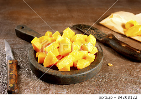 raw pumpkin on wooden plate, fresh pumpkin raw pumpkin on wooden plate, fresh pumpkin 84208122