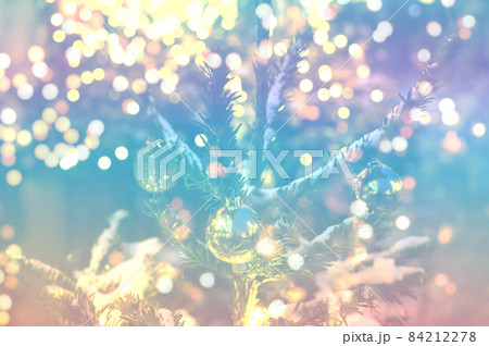 Delicate background of christmas tree branches with balls and blurry lights 84212278