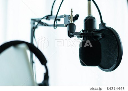 Headphones and condenser microphone in audio studio. Headphones and condenser microphone in audio studio. 84214463