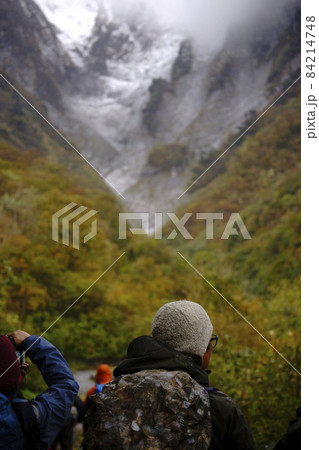 マチガ沢の岩肌と紅葉を背景にした登山者 84214748