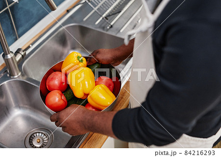 Man Washing Fresh Vegetables 84216293