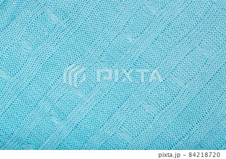 Blue coloured knitted surface. Closeup 84218720