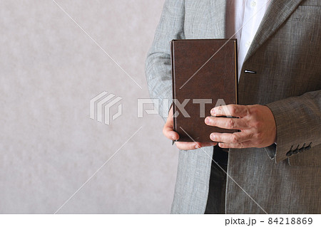 A book in a man's hands. Closeup 84218869