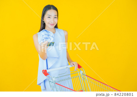 Portrait beautiful young asian woman smile with grocery basket 84220801