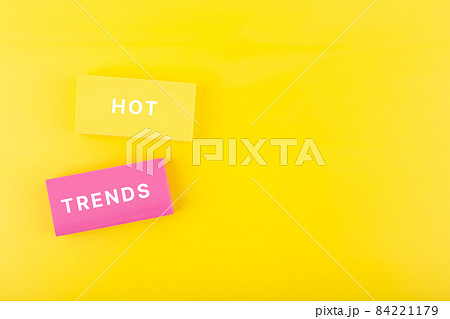 Hot trends written on colorful rectangles on light yellow background with copy space 84221179