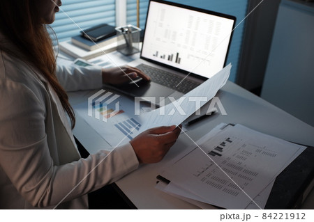 Young asian women working late at night using laptop in dark room Young asian women working late at night using laptop in dark room 84221912