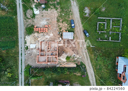 Top down aerial view of building works of new house concrete foundation on construction site. Top down aerial view of building works of new house concrete foundation on construction site. 84224560