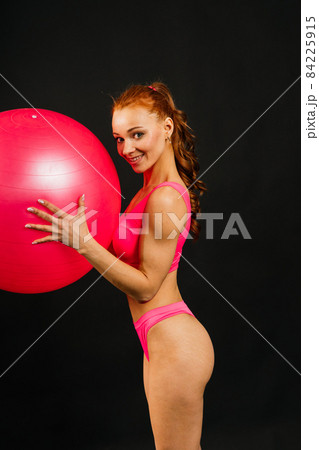 Portrait of seductive young woman looking at camera with muscular body ready for a workout Portrait of seductive young woman looking at camera with muscular body ready for a workout 84225915