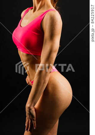 Portrait of seductive young woman looking at camera with muscular body ready for a workout Portrait of seductive young woman looking at camera with muscular body ready for a workout 84225917