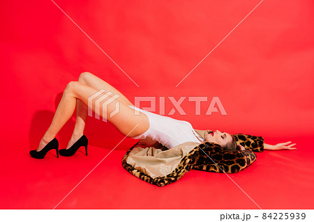Gorgeous young woman posing in luxurious fur coat and bodysuit. Fashion, beauty. Studio shot. Gorgeous young woman posing in luxurious fur coat and bodysuit. Fashion, beauty. Studio shot. 84225939