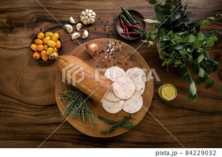 smoked chicken ham on rustic wood table with natural ingredients smoked chicken ham on rustic wood table with natural ingredients 84229032