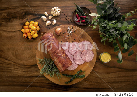 garlic ham sausage on rustic wood table with natural ingredients garlic ham sausage on rustic wood table with natural ingredients 84230310