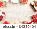 Christmas background with gift boxes on wooden table 84230404
