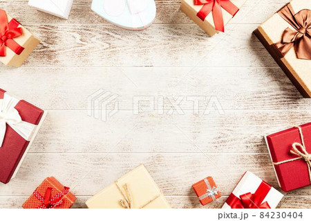 Christmas background with gift boxes on wooden table 84230404
