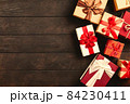 Christmas background with gift boxes on wooden table 84230411
