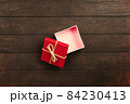 Christmas background with gift boxes on wooden table 84230413
