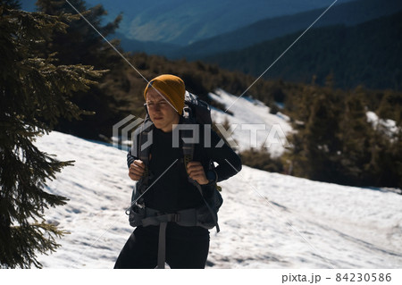 Young man is traveling, hiking in the mountains. Young man is traveling, hiking in the mountains. 84230586