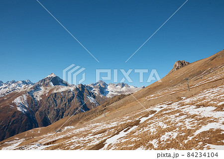 Dombay, alps, snow-covered slopes, the first snow in the mountains, sun and good weather, winter ski season Dombay, alps, snow-covered slopes, the first snow in the mountains, sun and good weather, winter ski season 84234104