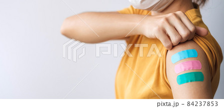 woman showing plaster after receiving covid 19 vaccine. Vaccination, herd immunity, side effect, booster dose, vaccine passport and Coronavirus pandemic woman showing plaster after receiving covid 19 vaccine. Vaccination, herd immunity, side effect, booster dose, vaccine passport and Coronavirus pandemic 84237853