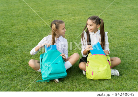 Group study outdoors girls classmates with backpacks, back to school concept Group study outdoors girls classmates with backpacks, back to school concept 84240045