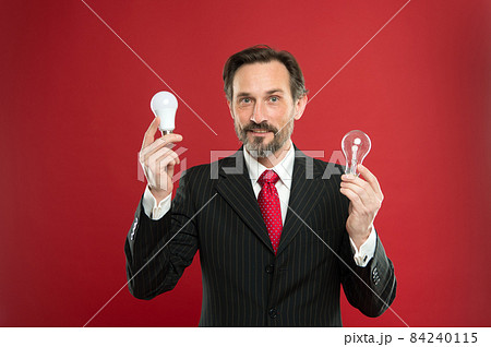 Man bearded businessman formal suit hold light bulb  84240115