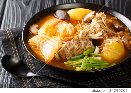 Korean Gamjatang is a spicy hearty stew made with pork bones close up in the bowl. Horizontal Korean Gamjatang is a spicy hearty stew made with pork bones close up in the bowl. Horizontal 84240205