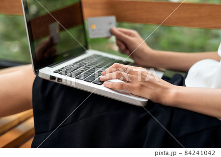 Asian woman using laptop and credit card shopping ecommerce Asian woman using laptop and credit card shopping ecommerce 84241042