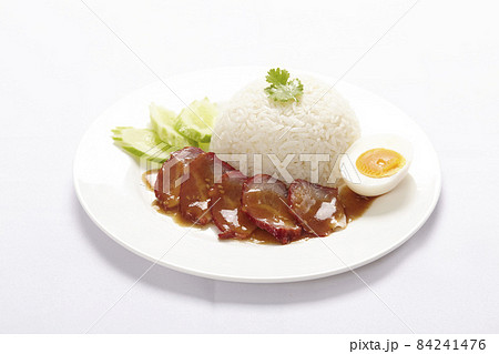 BBQ Pork and Crispy Pork on rice with sauce on white background. 84241476