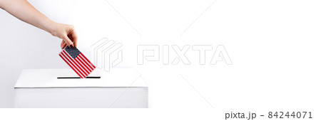 Woman puts the USA flag into voting box. Election concept, place for text. Banner format 84244071