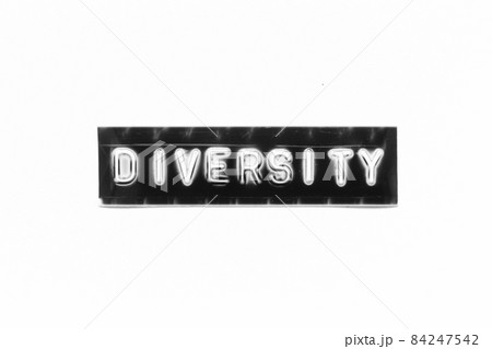 Embossed letter with word diversity in black banner on white paper background Embossed letter with word diversity in black banner on white paper background 84247542